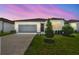 Charming single-story home with a two-car garage, well-manicured lawn, and landscaped garden at 3980 Big Sky Dr, Spring Hill, FL 34604