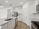 Bright kitchen with white cabinets, stainless steel appliances, and a spacious island for food preparation and dining at 3980 Big Sky Dr, Spring Hill, FL 34604