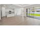 Bright, open-concept living space with modern finishes, seamlessly connecting the kitchen and outdoor area at 3980 Big Sky Dr, Spring Hill, FL 34604