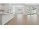 Spacious living area featuring hardwood floors, large windows, and an open layout ideal for entertaining at 3980 Big Sky Dr, Spring Hill, FL 34604