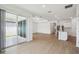 Open-concept living room with hardwood flooring, recessed lighting, and sliding glass doors to the outdoors at 3980 Big Sky Dr, Spring Hill, FL 34604