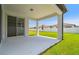 Covered patio offering an outdoor living space with a view of the green backyard at 3980 Big Sky Dr, Spring Hill, FL 34604