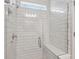 Luxurious shower featuring white subway tiles, a glass enclosure, and a built-in bench for comfortable showering at 3980 Big Sky Dr, Spring Hill, FL 34604