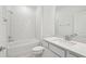 Bathroom boasts modern finishes, white cabinets, and a shower-tub combo at 4219 Big Sky Dr, Spring Hill, FL 34604
