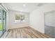 Bright bedroom with wood-look flooring, large windows, and sliding glass doors to the backyard at 4219 Big Sky Dr, Spring Hill, FL 34604