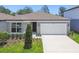 Charming single-Gathering home with a well-manicured front yard and attached two-car garage at 4219 Big Sky Dr, Spring Hill, FL 34604