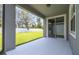Covered patio with an open view of the backyard and a sliding glass door entrance at 4219 Big Sky Dr, Spring Hill, FL 34604