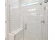 Modern shower features white subway tile, glass enclosure and bench seating at 4219 Big Sky Dr, Spring Hill, FL 34604