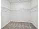 Empty walk-in closet with wire shelving and gray carpet flooring at 4219 Big Sky Dr, Spring Hill, FL 34604