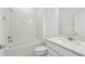 Clean, modern bathroom with white subway tile, tub and shower combination, and vanity at 4227 Big Sky Dr, Spring Hill, FL 34604