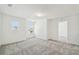 Bright bedroom featuring plush carpeting, two windows, fresh white walls, baseboards, and trim. Ready for personalization! at 4227 Big Sky Dr, Spring Hill, FL 34604