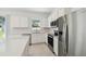 Bright kitchen boasts stainless appliances, white cabinets, and an open layout at 4227 Big Sky Dr, Spring Hill, FL 34604