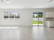 Bright open-concept living space with tile floors, natural light, and access to the backyard at 4227 Big Sky Dr, Spring Hill, FL 34604