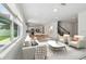 Open-concept living room with modern furnishings, sleek kitchen, and staircase leading to upper level at 4227 Big Sky Dr, Spring Hill, FL 34604