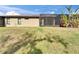 The backyard features a well-manicured lawn and screened in patio at 438 Seneca Falls Dr, Apollo Beach, FL 33572