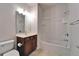 Bathroom with wood vanity, tiled floor and shower-tub combo at 438 Seneca Falls Dr, Apollo Beach, FL 33572