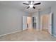 This bedroom features a ceiling fan, neutral paint, tile flooring, and an open closet at 438 Seneca Falls Dr, Apollo Beach, FL 33572