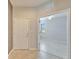 Inviting foyer with neutral tile flooring, a white front door, and an open view to the living area at 438 Seneca Falls Dr, Apollo Beach, FL 33572