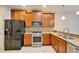 A modern kitchen features stainless steel appliances, granite countertops, and wood cabinetry at 438 Seneca Falls Dr, Apollo Beach, FL 33572