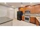 A modern kitchen features stainless steel appliances, granite countertops, and wood cabinetry at 438 Seneca Falls Dr, Apollo Beach, FL 33572