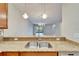 Kitchen bar overlooking dining area with a stainless steel sink and granite countertop at 438 Seneca Falls Dr, Apollo Beach, FL 33572