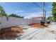 View of the backyard featuring a privacy fence, mulch, and a pink house on a sunny day at 4541 2Nd N Ave, St Petersburg, FL 33713