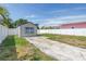 Backyard featuring partial grass, a concrete pad, and the back of the house with a white privacy fence at 4541 2Nd N Ave, St Petersburg, FL 33713
