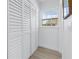 Walk-in closet area with louvered doors and natural light streaming through the window at 4541 2Nd N Ave, St Petersburg, FL 33713