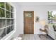 Bright entryway with a wooden door, white walls, and a view to the outside at 4541 2Nd N Ave, St Petersburg, FL 33713