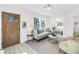 Bright living room featuring a comfortable gray sofa, stylish decor, and lots of natural light at 4541 2Nd N Ave, St Petersburg, FL 33713