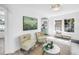 Sunlit living room boasts white walls, stylish seating, and modern decor for a welcoming atmosphere at 4541 2Nd N Ave, St Petersburg, FL 33713