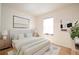 Cozy bedroom with soft, neutral tones, decorative art, and great natural light at 5511 N 32Nd St, Tampa, FL 33610