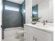 Bathroom featuring blue tiled walls, shower-over-tub, white vanity, and hexagon tile floor at 6207 64Th N Way, Pinellas Park, FL 33781