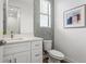 Half bath featuring mosaic accent wall, white vanity with ample storage, and modern fixtures at 6207 64Th N Way, Pinellas Park, FL 33781