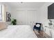 Bright bedroom with white walls, two closets, a blue accent chair, and light wood floors at 6207 64Th N Way, Pinellas Park, FL 33781