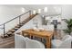 Dining area with staircase, wood table, and modern open floor plan to kitchen at 6207 64Th N Way, Pinellas Park, FL 33781