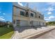 New construction townhome with three garage doors, modern design, and paver driveway at 6207 64Th N Way, Pinellas Park, FL 33781