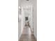 Hallway view leading to a sunlit bedroom, showcasing modern flooring and neutral decor at 6207 64Th N Way, Pinellas Park, FL 33781