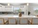 Bright kitchen with white cabinets, stainless steel appliances, subway tile backsplash, and a large island with bar seating at 6207 64Th N Way, Pinellas Park, FL 33781