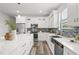Modern kitchen with white cabinets, stainless steel appliances, subway tile backsplash, and a large island at 6207 64Th N Way, Pinellas Park, FL 33781
