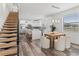 Bright open-plan kitchen with white cabinetry, large island, stainless steel appliances and adjacent dining area at 6207 64Th N Way, Pinellas Park, FL 33781