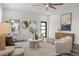 Bright living room with neutral furniture, modern art, hardwood floors, and lots of natural light at 6207 64Th N Way, Pinellas Park, FL 33781