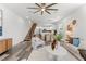 Bright living room with open floor plan, modern staircase, wood floors, and contemporary decor at 6207 64Th N Way, Pinellas Park, FL 33781