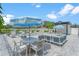 Community pool area with lounge chairs, tables with umbrellas, metal fence and landscaping at 6207 64Th N Way, Pinellas Park, FL 33781