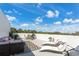 Rooftop patio featuring outdoor lounge furniture, dining area, and sun loungers with sky view at 6207 64Th N Way, Pinellas Park, FL 33781