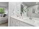 Bathroom featuring double sinks, a large mirror, and a modern aesthetic at 6212 Timberdale Ave, Wesley Chapel, FL 33545