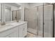Bathroom featuring a double sink vanity, glass-enclosed shower, and tiled flooring at 6224 Timberdale Ave, Wesley Chapel, FL 33545