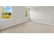 A carpeted bedroom with neutral paint and windows at 6224 Timberdale Ave, Wesley Chapel, FL 33545