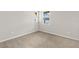 A carpeted bedroom has neutral paint with two windows that provide natural light at 6224 Timberdale Ave, Wesley Chapel, FL 33545