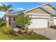 Charming single-Gathering home with a brick driveway and a two-car garage, enhanced by lush landscaping at 6224 Timberdale Ave, Wesley Chapel, FL 33545